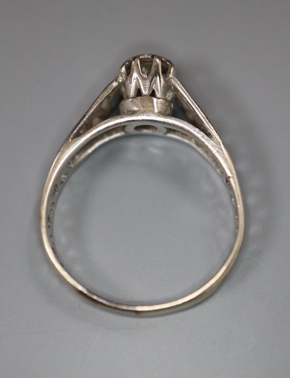 A diamond and 18ct white gold solitaire ring with pierced shank, size L/M, gross 2.9 grams.